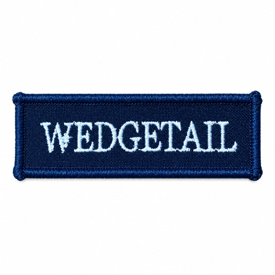 Navy blue embroidered patch with white ’wedgetail’ lettering and a small bird emblem above the ’e’