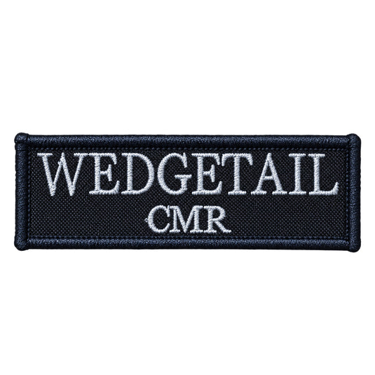 Black embroidered patch with white thread lettering reading ’wedgetail cmr’