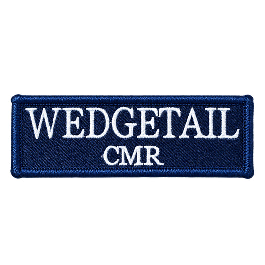 Navy blue embroidered patch with white stitched lettering reading ’wedgetail cmr’